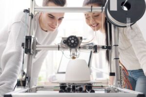 Close-up of 3D printing equipment creating a prototype.