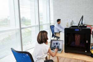 A professional 3D printer in a workspace, ready for production